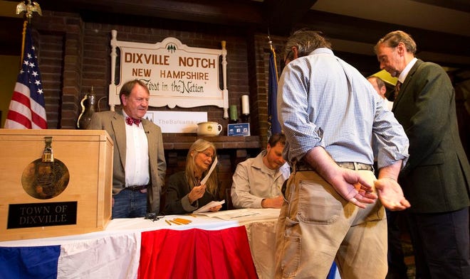 Voters in Dixville Notch, N.H., get their ballots Tuesday, Nov. 8, 2016, in Dixville Notch, N.H. The residents in town voted just after midnight.