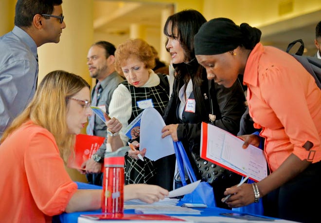 In this photo from Nov. 2, 2016, job seekers attend the New York Department of Citywide Administrative Services job fair, in New York. The Labor Department said Tuesday, Nov. 8, that U.S. employers posted slightly more job openings in September, a likely sign that the steady job gains of recent months could continue.