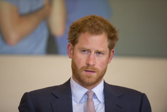 Prince Harry takes part in a discussion with HIV doctors at King's College Hospital in south London on July 7, 2016. Prince Harry has condemned racist abuse and harassment of his girlfriend Meghan Markle in the media, issuing a highly unusual statement Tuesday Nov. 8, 2016, that confirmed the relationship and expressed concern for her safety. (AP Photo/Matt Dunham, Pool, File)