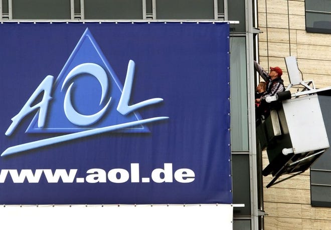 In this March 17, 2000, file photo, window cleaners work at the front of the headquarters of AOL Europe in Hamburg, Germany. A California woman stumbled upon a voice from the past during a trip to Ohio over the weekend when she discovered her Uber driver was the man behind America Online's famous "You've Got Mail" greeting.