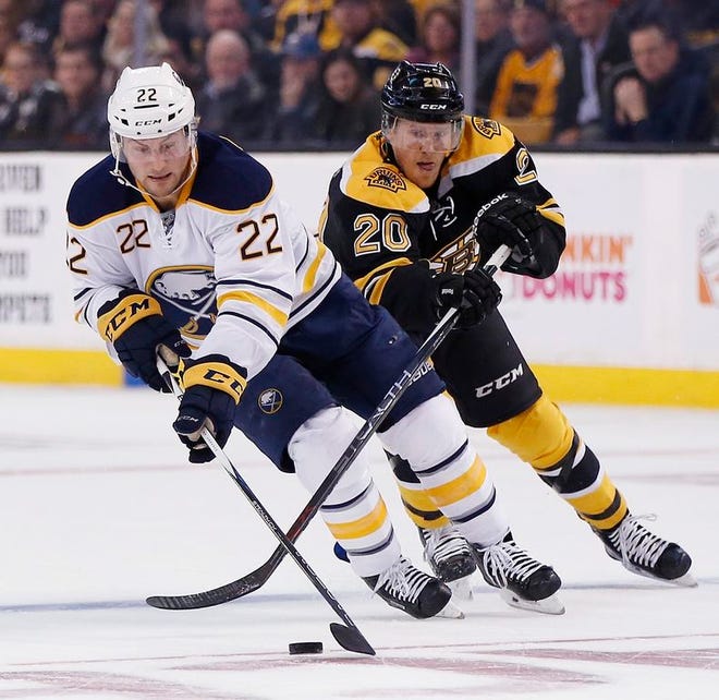Boston Bruins' Riley Nash, right, battles for the puck with Buffalo Sabres' Johan Larsson during the first period of an NHL hockey game in Boston, Monday, Nov. 7, 2016.