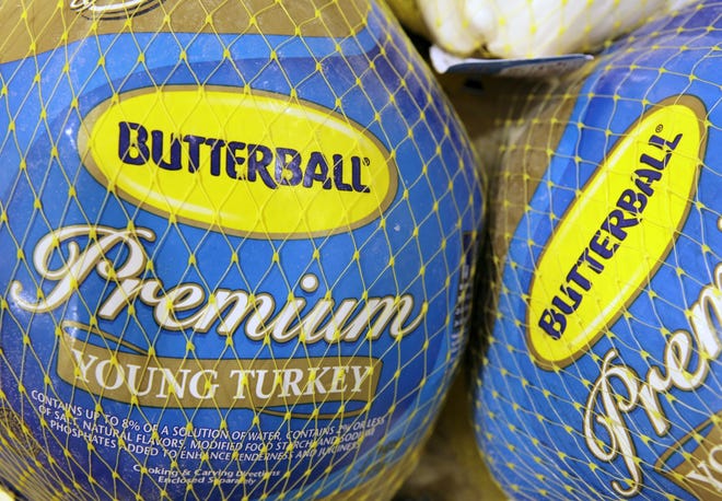 In this file photo made Dec. 7, 2009, Butterball frozen turkeys are on display at Heinen's grocery store in Bainbridge Township, Ohio. Butterball, which has been fielding phone calls from Thanksgiving cooks for more than 35 years, is letting people text their turkey-related questions this year for the first time. (AP Photo/Amy Sancetta, File)