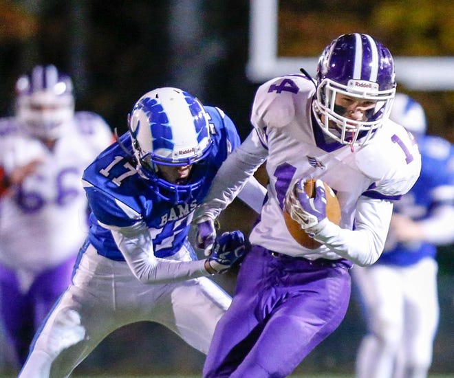 Marshwood's Joe Taran, right, tries to escape the grasp of Kennebunk defender Justin Wiggins during Friday night's Class B South semifinal game in Kennebunk, Maine. The Hawks lost 13-7, ending their string of four straight trips to the regional final. 

Photo by Stewart Mellentine