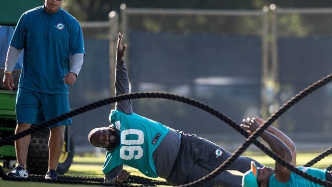 Miami Dolphins defensive tackle Earl Mitchell (90) and Miami Dolphins defensive end Dion Jordan (95) (right) work on the side at Miami Dolphins training camp in Davie, Florida on August 10, 2016. (Allen Eyestone / The Palm Beach Post)