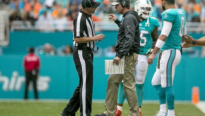 Miami Dolphins head coach Adam Gase, (C), has a conversation with a referee after a flag was thrown on a play during second half action of their NFL game Sunday November 06, 2016 at Hard Rock Stadium in Miami Gardens. (Bill Ingram / The Palm Beach Post)