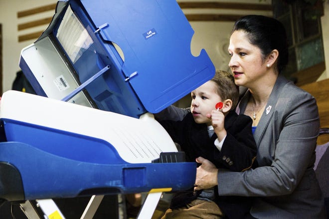 City Clerk Susana Mendoza votes with her son David Quinten at the poling station for precinct 33 in Chicago, Tuesday, Nov. 8 2016. Mendoza defeated incumbent Leslie Munger in the Illinois state comptroller race. JAMES FOSTER/CHICAGO SUN-TIMES VIA AP
