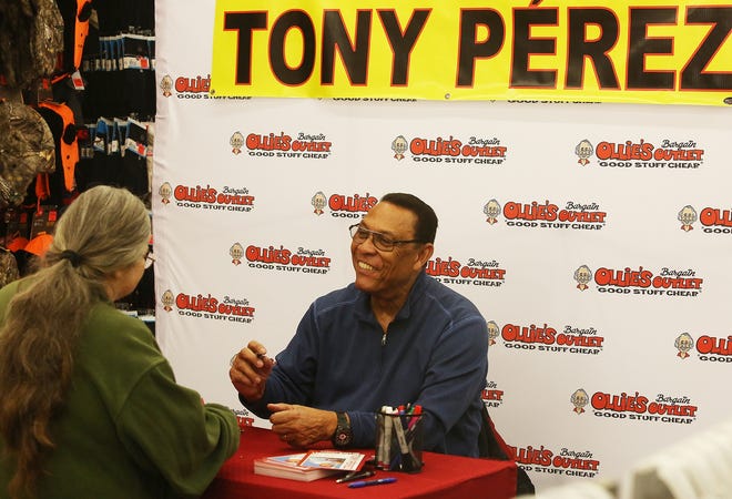 Baseball Hall of Famer Tony Perez signs autographs Wednesday morning at the grand opening of Ollie's Bargain Outlet in the Heritage Square in Dover. (TimesReporter.com/Jim Cummings)