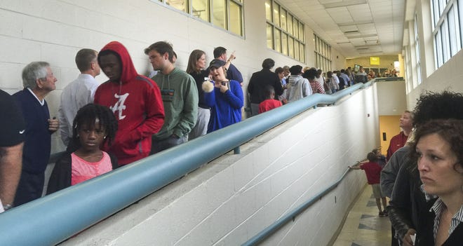 A long line of voters wait inside the Phelps Activity Center polling station in Tuscaloosa on Tuesday morning. Photo/Lynnie Guzman