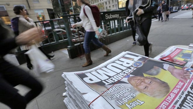 Pedestrians walk past a New York Post headline announcing President-elect Donald Trump’s victory on Wednesday. “The right-wing media Trump empowered have circulated absurd conspiracies and lies,” Mona Charen writes.