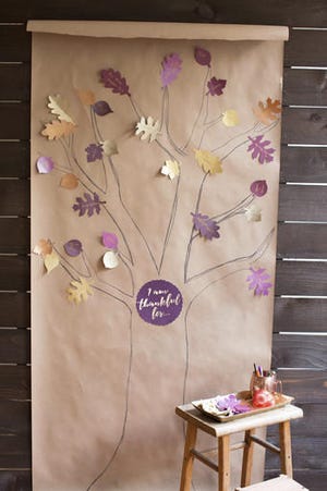 This undated photo provided by www.LiaGriffith.com, shows a paper "thankful tree," which is a whimsical addition to Thanksgiving dinner decorating, says crafter Lia Griffith, but it's also a great way to keep kids busy during meal preparation and help them focus on the real meaning of the holiday. Griffith offers downloadable leaf patterns and a printable sign for the center at her website. (Lia Griffith via AP)
