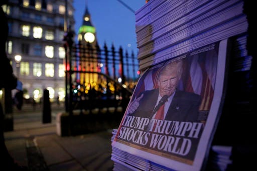 Copies of the London Evening Standard newspaper report on President-elect Donald Trump winning the American election, backdropped by the Houses of Parliament in London, Wednesday, Nov. 9, 2016. Republican candidate Trump secured victory in Tuesday's U.S. presidential election.
