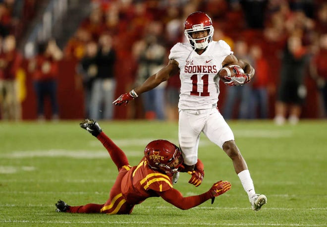 FILE - In this Nov. 3, 2016, file photo, Oklahoma wide receiver Dede Westbrook (11) runs from Iowa State defensive back D'Andre Payne during the first half of an NCAA college football game, in Ames, Iowa. Westbrook is having the best stretch of games ever by an Oklahoma receiver. Still, the Big 12 isnâ€™t likely to have a player in New York next month for the Heisman Trophy ceremony. (AP Photo/Charlie Neibergall, File)