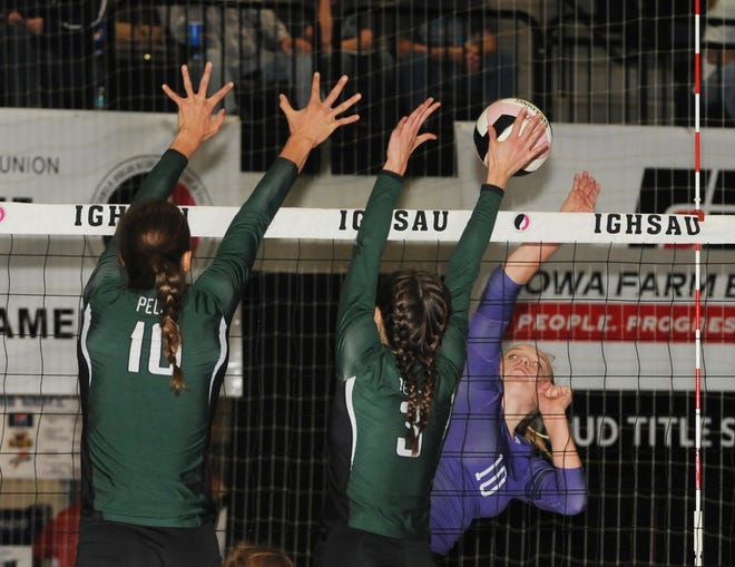 Nevada's Morgan Tupper goes for a kill against Pella's Emily Holterhaus (left) and Kiki Pingel during the opening set of the Cubs' Class 4A state quarterfinal match with the Lady Dutch Tuesday in Cedar Rapids. The No. 9 Cubs fell to the No. 1 Lady Dutch in three sets.