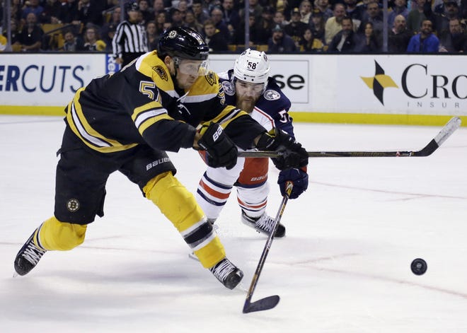 Boston Bruins center Ryan Spooner (51) shoots against Columbus Blue Jackets defenseman David Savard (58) in the second period of an NHL hockey game, Thursday, Nov. 10, 2016, in Boston. (AP Photo/Elise Amendola)