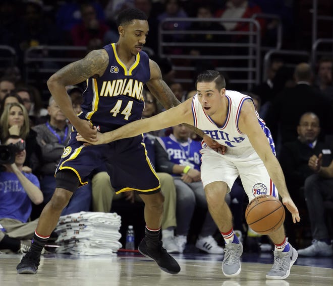 The 76ers' T.J. McConnell tries to dribble past the Pacers' Jeff Teague (44) during Friday night's game at the Wells Fargo Center. (AP Photo/Matt Slocum)