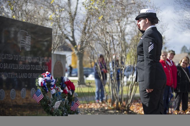 United States Navy Seaman Brittany Lloyd salutes after laying a wreath honoring America's sailors during a Veterans Day ceremony at the Rochester Common. Photo by John Huff/Fosters.com