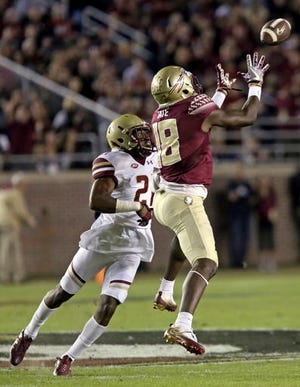Florida State's Auden Tate tries to catch the ball as Boston College's Lukas Denis defends in the first quarter of game Friday night in Tallahassee, Fla. AP PHOTO/STEVE CANNON