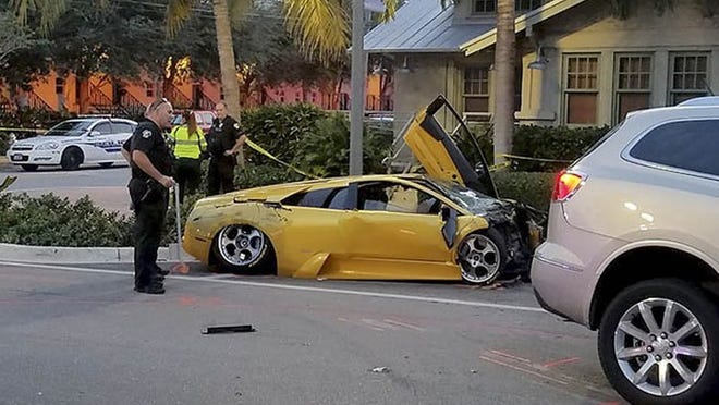 A Delray Beach Police officers gathers information at the scene of a three car accident involving a Lamborghini that collided collision with an SUV Wednesday afternoon, September 21, 2016 in Delray Beach, police said. One man was killed and another sustained serious injuries. (Photo courtesy of Bill Bathurst)