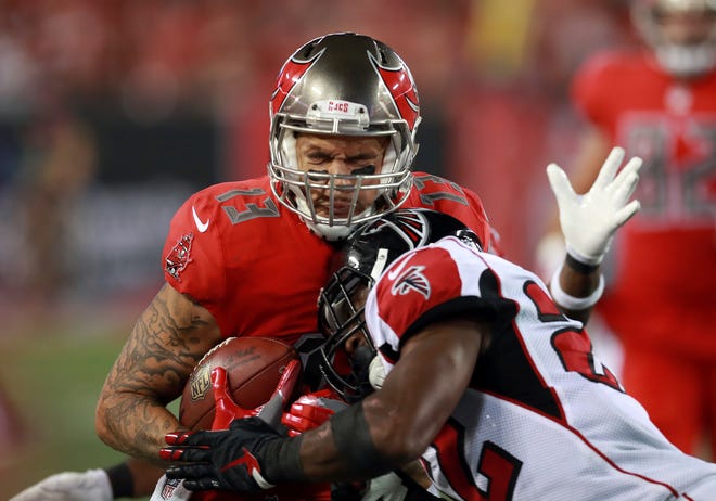 In this Nov. 3, 2016, file photo, Tampa Bay Buccaneers wide receiver Mike Evans (13) makes catch as Atlanta Falcons safety Keanu Neal (22) tackles him during a game in Tampa, Fla.  Safety Keanu Neal, linebackers Deion Jones and De'Vondre Campbell and nickel back Brian Poole are rookie starters for the Falcons' defense, an unusual commitment to youth, especially for a first-place team as it prepares to play at the Eagles. (Jeff Haynes/AP File Photo)