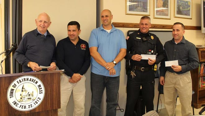 Town department representatives were on hand at the annual Fairhaven Road awards luncheon to receive $2,000 donations from the race committee. From left to right, EMA volunteer John Rogers, Fire/EMS Dept. representative Wayne Oliveira, Police Dept. sergeants Michael Botelho and Kevin Kobza, and Fire Dept. member Todd Correia.

ROBERT BARBOZA/ADVOCATE/SCMG