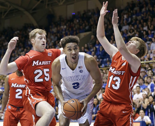 Duke forward Chase Jeter (2) drives between Marist center Connor McClenaghan (25) and Marist guard Kristinn Palsson (13) during Marist's 94-49 loss on Friday night in Durham, N.C. Associated Press
