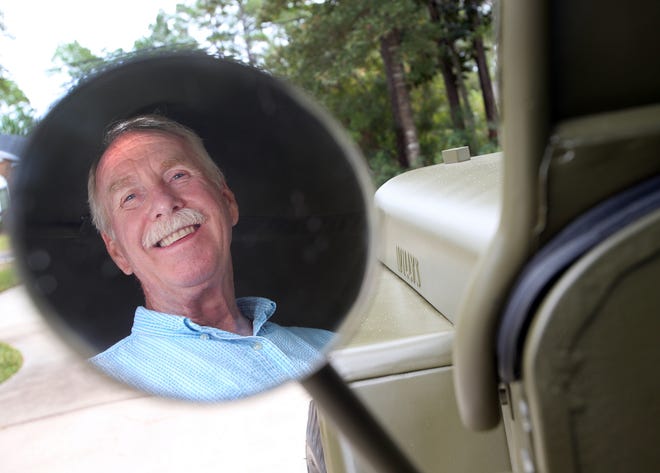 Veteran Jim White talks sits in the drivers seat of his restored 1948 Willy's Jeep at his Lynn Haven home Wednesday. ANDREW WARDLOW/THE NEWS HERALD