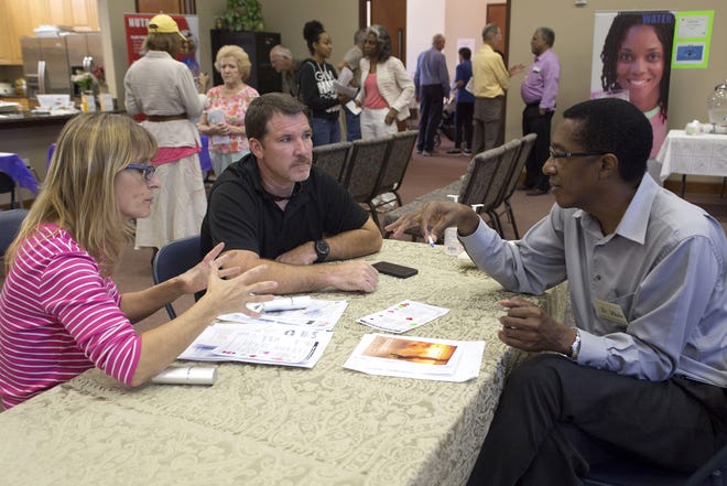 Dr. Perth Blake, right, discusses results with participants at the free health fair last Sunday at the Umatilla Seventh-day Adventist Church. CINDY DIAN / CORRESPONDENT