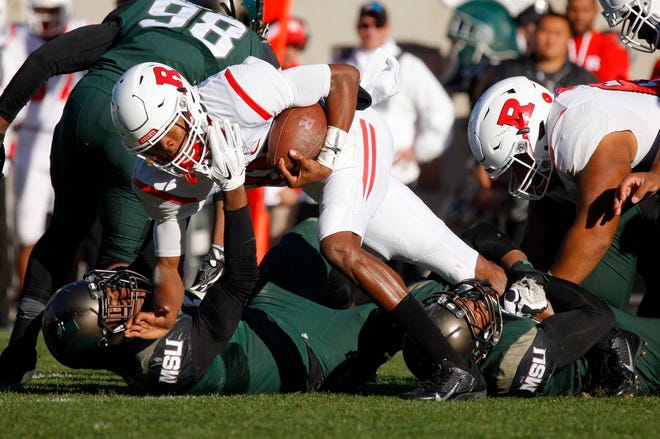Rutgers quarterback Tylin Oden, center, is tackled by Michigan State's Andrew Dowell, left, and Robert Bowers, right, during the fourth quarter of an NCAA college footballl game, Saturday, Nov. 12, 2016, in East Lansing, Mich. (AP Photo/Al Goldis)