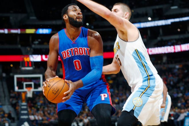 Detroit Pistons center Andre Drummond, left, goes up for a basket as Denver Nuggets forward Nikola Jokic, of Serbia, defends in the first half of an NBA basketball game Saturday, Nov. 12, 2016, in Denver. (AP Photo/David Zalubowski)