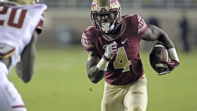 Florida State’s Dalvin Cook looks to get past Boston College’s Isaac Yiadom during the Seminoles’ rout of the Eagles on Friday night in Tallahassee. (AP Photo/Steve Cannon)