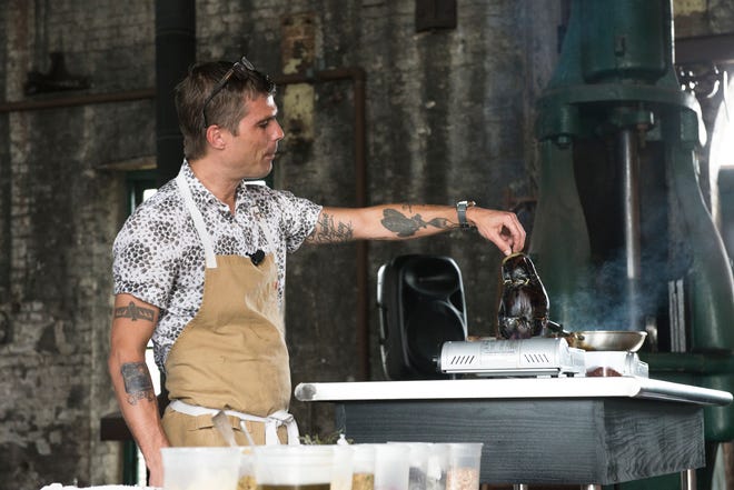 Chef Hugh Acheson demonstrates cooking tartine of roasted eggplant at Taste of Savannah at the Roundhouse Railroad Museum. Taste of Savannah is an event of the Savannah Food and Wine Festival. (Siobhan Egan/For the SMN)