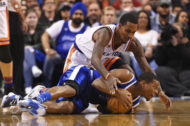 Knicks guard Brandon Jennings (3) and Toronto Raptors guard Kyle Lowry (7) battle for the ball during Saturday night's game in Toronto. Associated Press