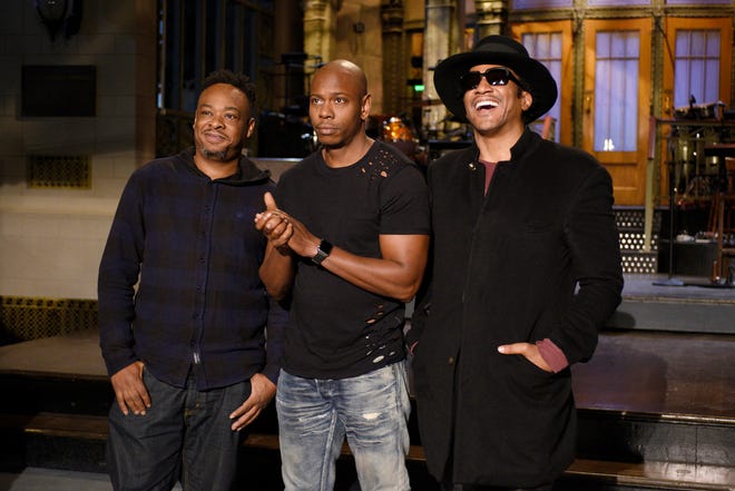 In this Nov. 10, 2016 photo released by NBC, Jarobi White and Q-Tip of musical guest A Tribe Called Quest pose with host Dave Chappelle, center, on the television show, “Saturday Night Live,” in New York. “Saturday Night Live” called on host Chappelle’s wit for a thoughtful coda to a divisive presidential campaign. Chappelle offered an African-American take on President-elect, Donald Trump’s victory over Hillary Clinton, saying he hadn’t seen white people so mad since the O.J. Simpson verdict. (Rosalind O’Connor/NBC via AP)