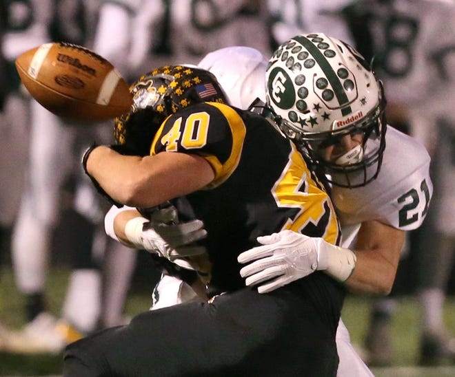 Central Catholic's Tee Rupp hits Black River's Cory Bartolic, causing an incomplete pass in Saturday's Division V regional semifinal. (GateHouse Ohio Media/Scott Heckel)