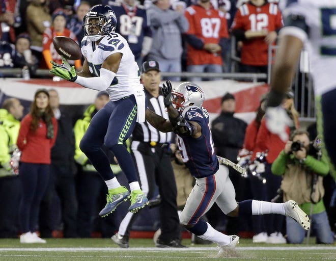 Seattle Seahawks cornerback DeShawn Shead (35) intercepts a pass intended for New England Patriots wide receiver Malcolm Mitchell, right, during their game Sunday night in Foxborough, Mass. Photo by AP