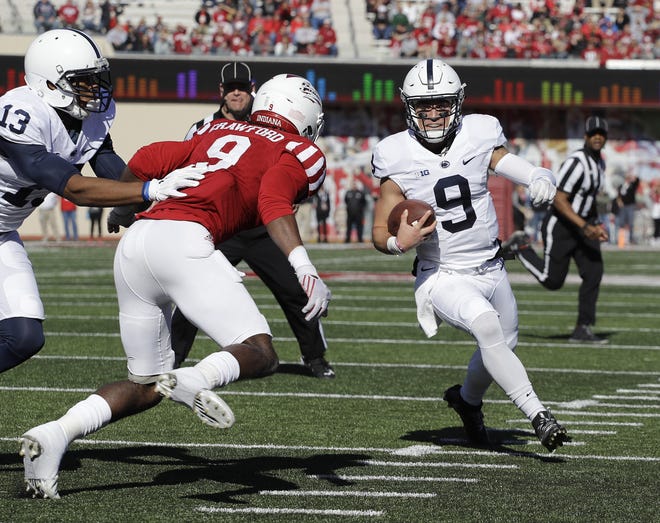 Penn State quarterback Trace McSorley runs 10 yards for a touchdown against Indiana's Jonathan Crawford (9) on Saturday. Penn State won 45-31. (AP Photo/Darron Cummings)