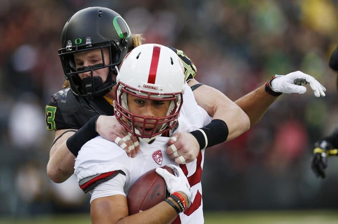 Stanford wide receiver JJ Arcega-Whiteside hauls Oregon's Brenden Schooler into the end zone for the Cardinal's third touchdown in the first quarter at Autzen Stadium in Eugene. (Andy Nelson/The Register-Guard)