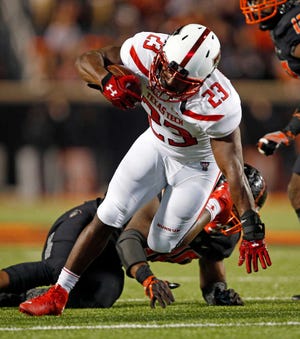 Texas Tech's Quinton White (23) tries to avoid a tackle on Saturday in Stillwater, Okla.