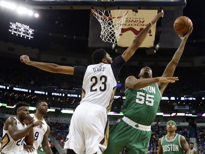 Celtics forward Jordan Mickey (right) goes up for a shot against Pelicans forward Anthony Davis during the first half of Boston's 106-105 loss on Monday night.