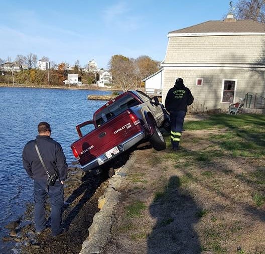 A truck was left teetering over a Cohasset Pond on Saturday after a driver lost control while backing out of his driveway.