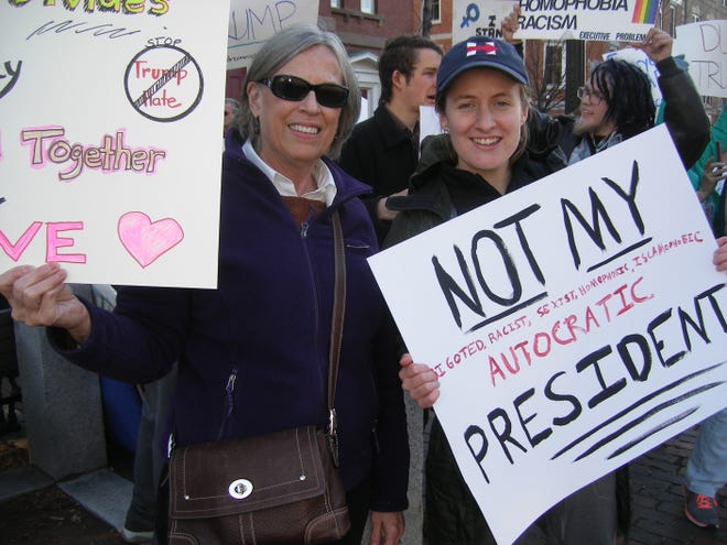 Janet Stephens of Exeter, left, and Clara Berry of Newburyport, Mass., were among the anti-Trump protesters at a rally held in front of the North Church on Sunday.

Shir Haberman photo