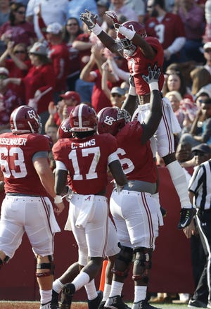 Alabama offensive lineman Lester Cotton (66) lofts teammate Alabama wide receiver Trevon Diggs (7) into the air as they celebrate Diggs' touchdown during the Crimson Tide's 51-3 win over western division foe Mississippi State on Nov. 12. Staff Photo/Gary Cosby Jr.