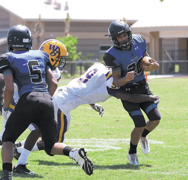 Sue Jarrett/For Bluffton Today May River running back Dion Lollis is wrapped up against Whale Branch.