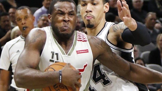 Miami Heat guard Dion Waiters (11) drives on San Antonio Spurs forward Danny Green (14) during the first half of an NBA basketball game on Monday, Nov. 14, 2016, in San Antonio. (AP Photo/Ronald Cortes)