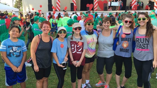 Representing Wellington Elementary School in the Palm Beach Heart Walk in downtown West Palm Beach were (from left) Danny Ruchti, ESE teacher Jennifer Laham, Alex Bayer, McKenna Tosner, Ceci Ruchti, VPK teacher Cathy Eckstein, Caleigh Tosner and Olivia Ruchti. The Wellington Wildcats walked a total of 3.3 miles each. Laham was a finalist for the Healthy Lifestyle Change Award. CONTRIBUTED