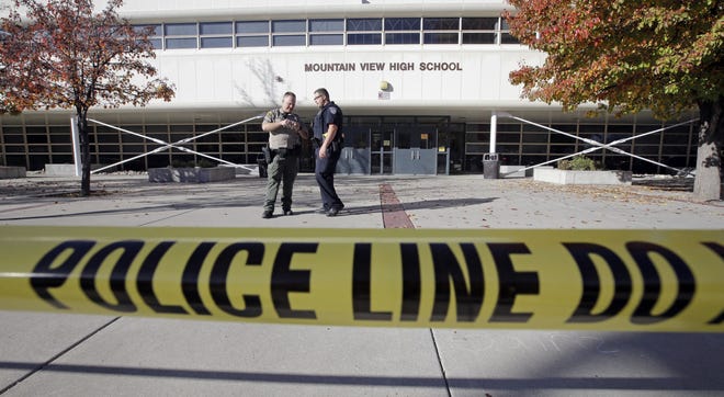 Police stand outside Mountain View High School after several students were stabbed inside the high school Tuesday, Nov. 15, 2016, in Orem, Utah Police say a 16-year-old boy was taken into custody after the stabbings. (AP Photo/Rick Bowmer)