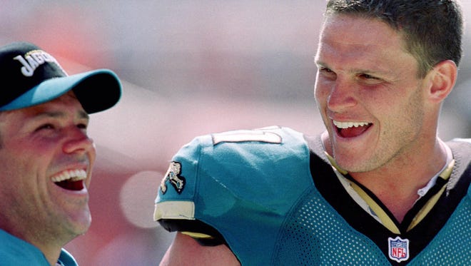 Former Jacksonville Jaguars quarterback #8 Mark Brunell (left) and former offensive tackle Tony Boselli have a laugh while standing on the sideline during the closing minutes of the Jaguars season opening 27-7 victory over the Cleveland Browns on Sept. 3, 2000. (Rick Wilson/Florida Times-Union file photo)