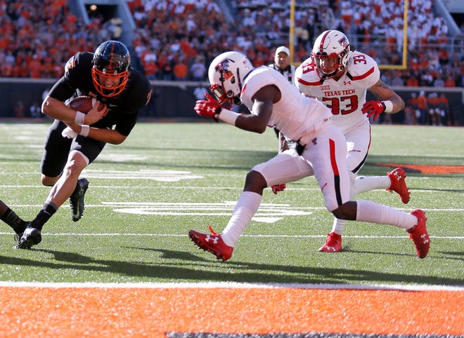 OSU quarterback Mason Rudolph barrels in for a touchdown against Texas Tech last season. (Photo by Sarah Phipps)