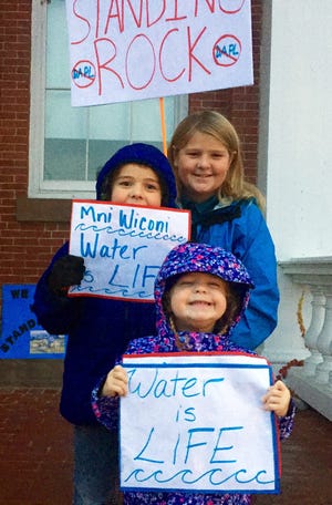 From the bottom up, Annie, Oscar and Max Ronner-Bland were excited to show their support for the Standing Rock Sioux. Annie was seen chanting, "Water is life!" Hadley Barndollar/Seacoastonline