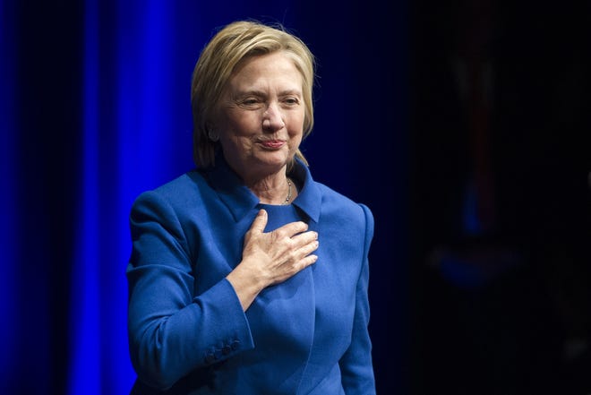Hillary Clinton places her hand over her hand as she walks to the podium to address the Children's Defense Fund's Beat the Odds celebration at the Newseum in Washington, Wednesday, Nov. 16, 2016. (AP Photo/Cliff Owen)